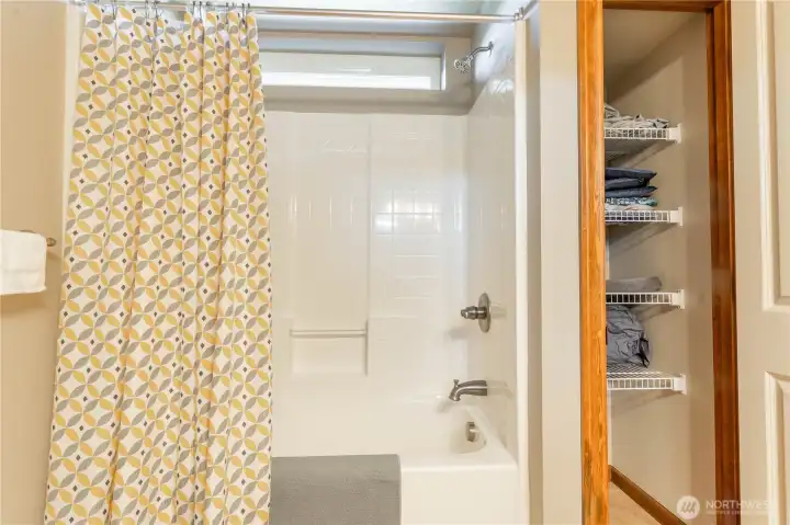 FULL second bath has a small long rectangle window above with storage closet behind the door shown here to the right.