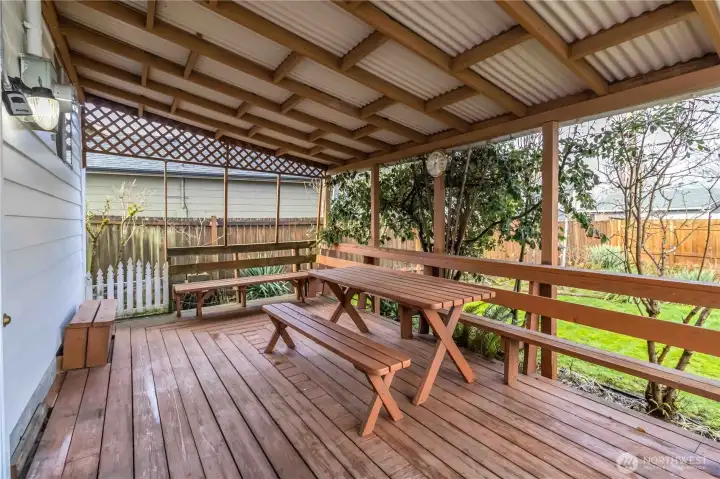 Covered Deck in Backyard with Entrance to Home
