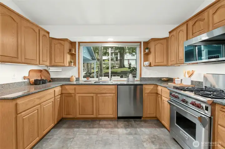 This large kitchen offers lots of counter space, room to move around new diswasher and microwave and a Wolf workhorse of a range!