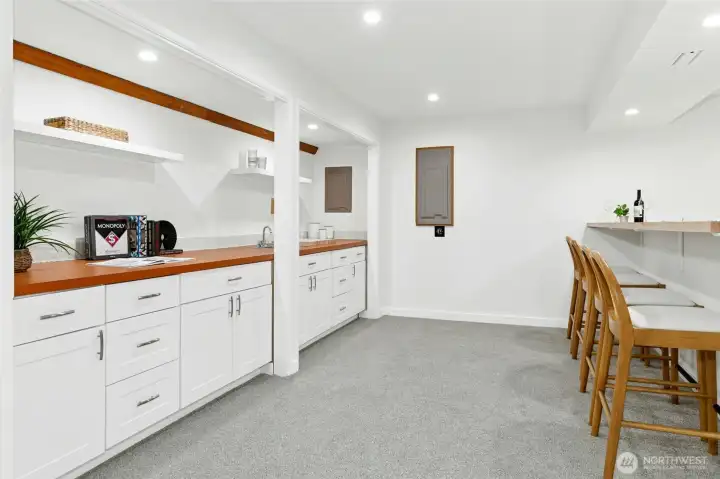 This storage and counter area has a functioning bar sink, and is plumbed for a future dishwasher should you wish to install one.