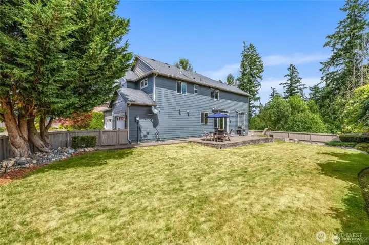 Level lawn and private backyard backed by a quiet greenbelt.