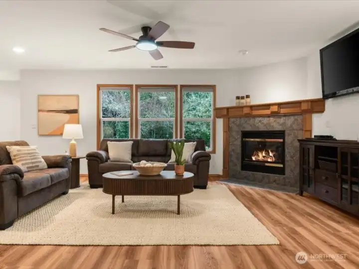 Dramatic window wall, frames in views of backyard and greenbelt, creating a feeling of being one with nature