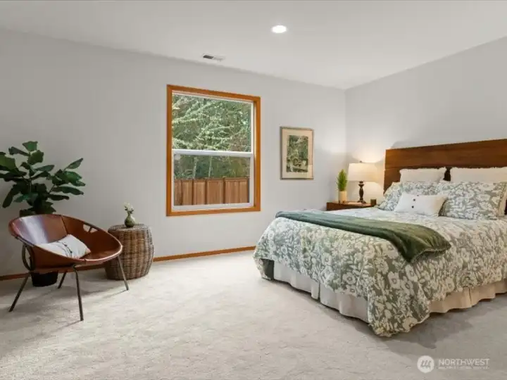 Versatile flex room on the main floor, ideal as a guest bedroom or office, fits a king or queen bed and dresser comfortably