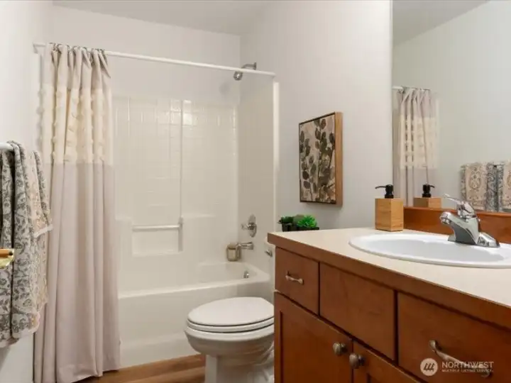 One of three upstairs full bathrooms, thoughtfully position near a secondary bedroom for added convenience
