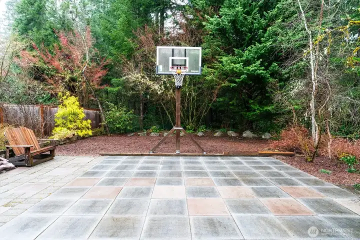 Pavered area off back of home, can double as additional outdoor living space or basketball court