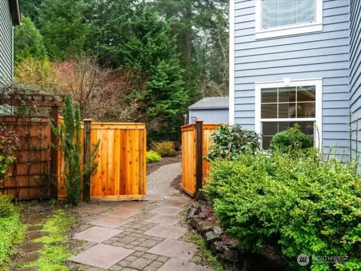 Double side gate and pavered walkway, allows for easy access connecting front and back yards for movement of landscaping materials