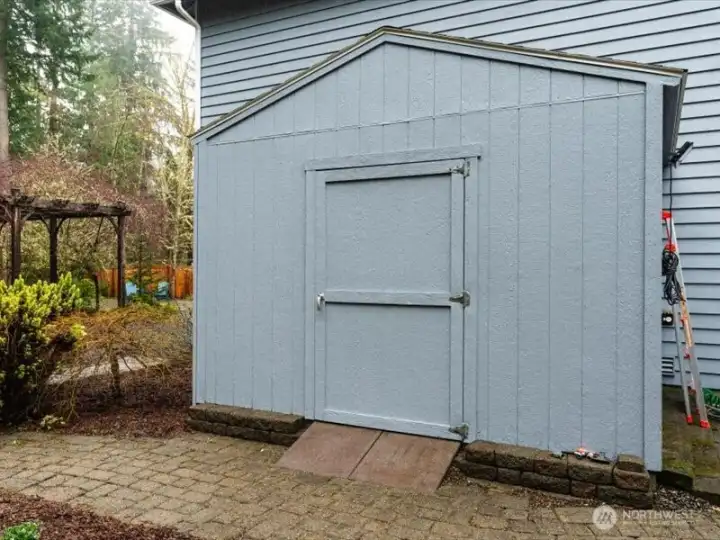 Large garden shed, perfect for storing yard equipment and/or outdoor furniture, conveniently located away from view of house with easy access