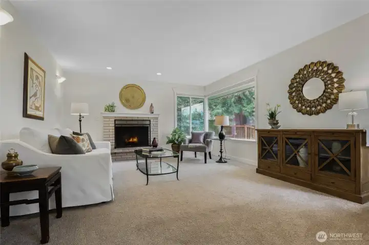 Living room is just two steps up from the dining room (great separation), with a wood fireplace and bright windows.