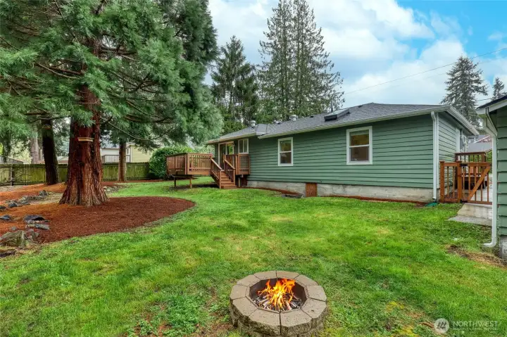 Inviting backyard with a firepit, fully fenced for privacy and enjoyment.