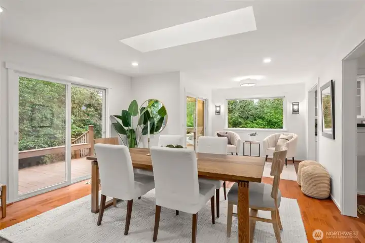 Bathed in natural light with a sliding glass door to the expansive wraparound deck