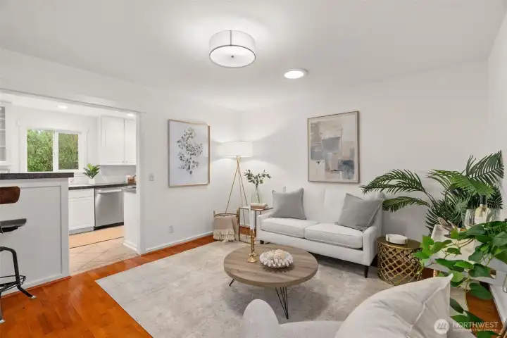 Dining room staged as a sitting room with the breakfast bar to the left.