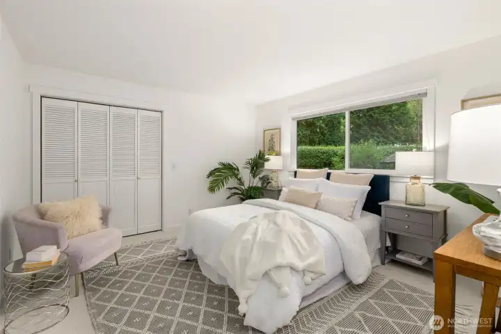Bedroom number two with room for a sitting area, console table and nightstands.