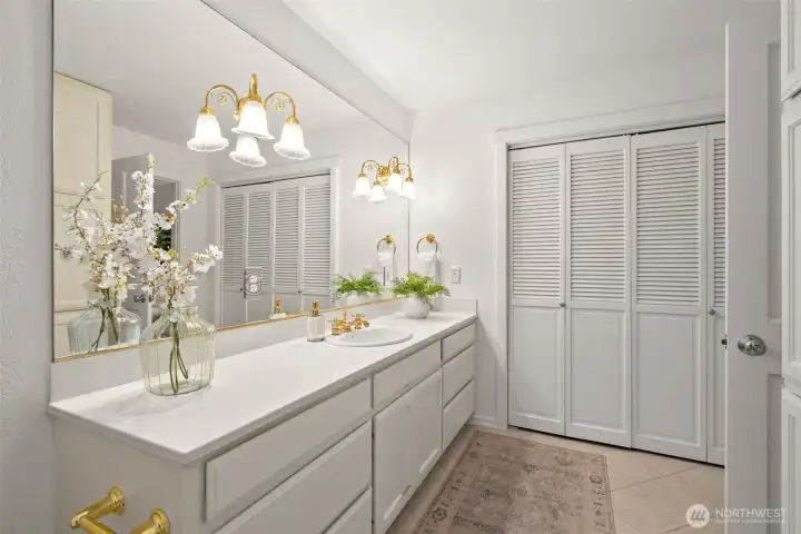 The full bathroom serving the primary bedrooms with a linen, toiletries closet.