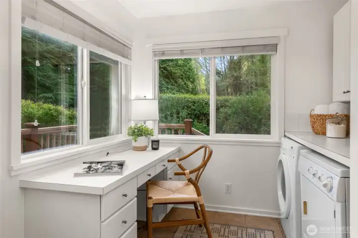 The laundry room doubles as an office with a built in desk.