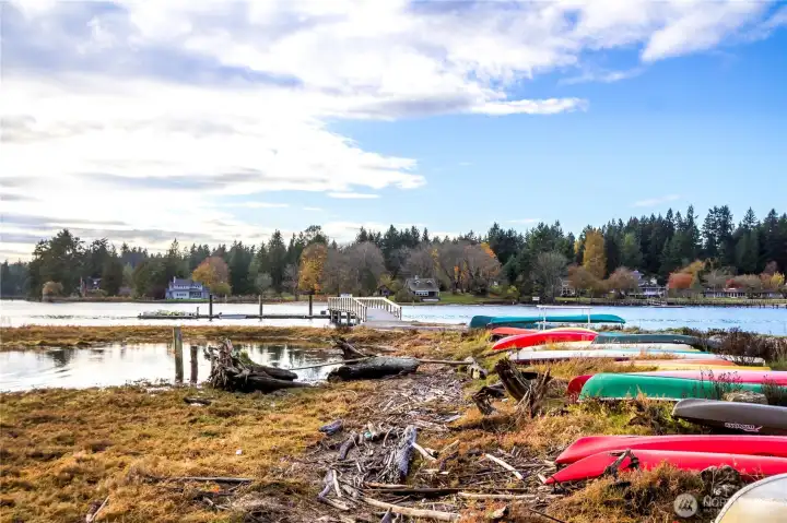 Private community beach with members kayaks and watercraft.
