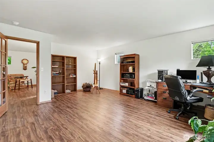 This ante room off the main level living area, currently being used as an office,  has a private staircase leading up to the primary suite