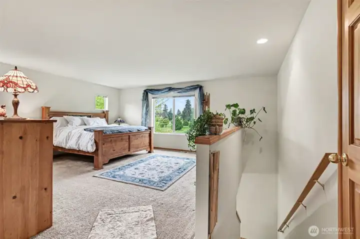 Primary suite with double doors showing separate staircase up from the main floor ante room