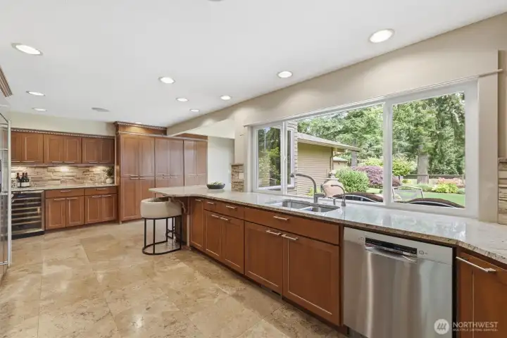 Ample custom cabinets provide storage galore. Don't miss the wine cooler!