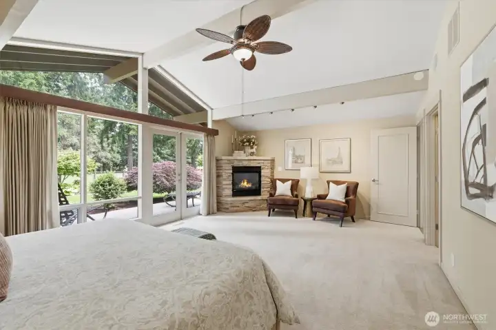 Your vaulted primary suite offers dramatic windows framing views to the golf course.