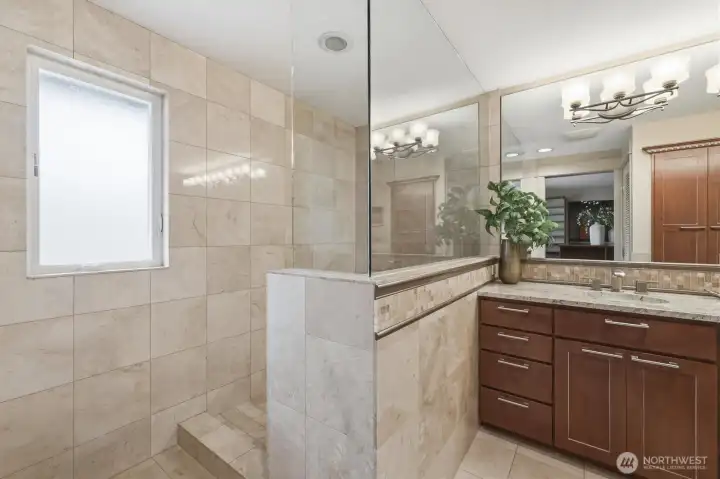 Walk-in shower dressed in luxurious Travertine tile.