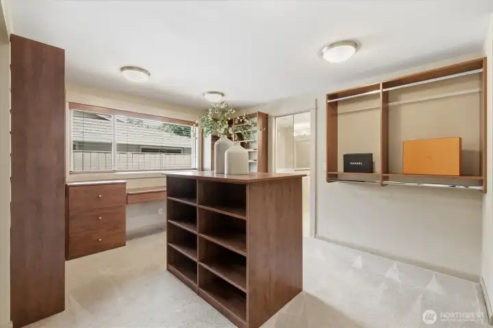 Dream walk-in closet in the primary suite features custom organizers.