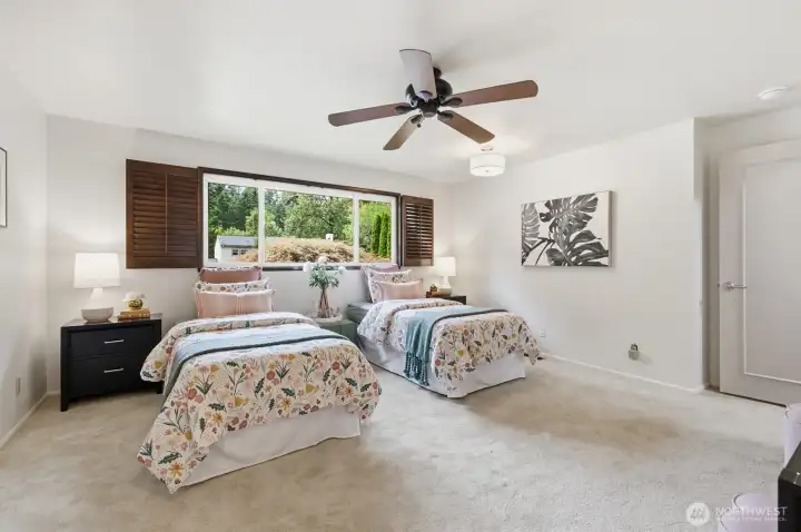Second bedroom with generous proportions & breezy ceiling fan.