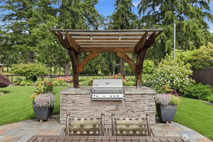 Covered BBQ station with built-in natural gas grill & rear storage cabinet.