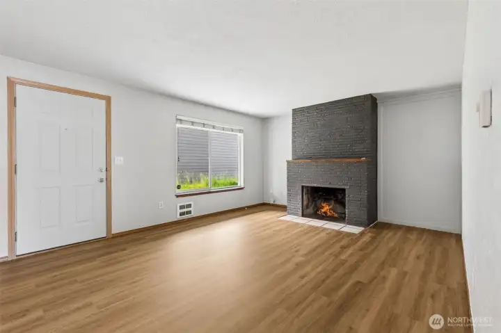 Living Room with new Luxury Vinyl Plank (LVP). Fireplace is decorative only.