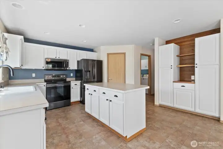 Anohter view of the kitchen and showing the corner pantry to the right of the stove