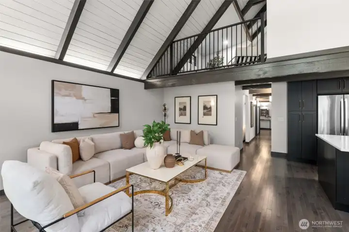Experience the ultimate in open-concept living in this breathtaking contemporary residence. The centerpiece of the home is a dramatic great room defined by soaring wood ceilings with exposed architectural beams and an expansive wall of windows that seamlessly connects the indoors with nature.    Step into a space designed to take your breath away. This spectacular open-concept great room effortlessly pairs bold, contemporary lines with the organic warmth of soaring, all-wood beamed ceilings. But the true showstopper is the massive wall of windows—featuring 20-foot wide sliding glass doors that effortlessly glide open to blur the line between inside and out. The entire space flows seamlessly onto a huge custom deck, creating an unparalleled layout for summer entertaining or peaceful morning coffees. At the heart of it all sits a gourmet chef’s kitchen, complete with quartz countertops, an abundance of sleek cabinetry, glowing under-cabinet lighting. This is a "home experience"!