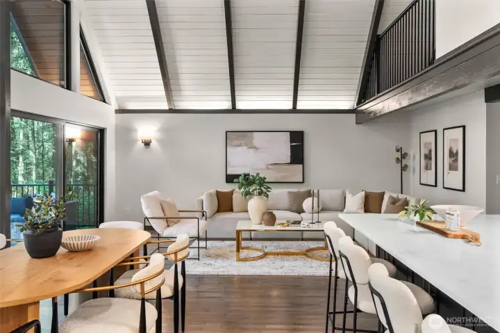 Experience the ultimate in open-concept living in this breathtaking contemporary residence. The centerpiece of the home is a dramatic great room defined by soaring wood ceilings with exposed architectural beams and an expansive wall of windows that seamlessly connects the indoors with nature.    Step into a space designed to take your breath away. This spectacular open-concept great room effortlessly pairs bold, contemporary lines with the organic warmth of soaring, all-wood beamed ceilings. But the true showstopper is the massive wall of windows—featuring 20-foot wide sliding glass doors that effortlessly glide open to blur the line between inside and out. The entire space flows seamlessly onto a huge custom deck, creating an unparalleled layout for summer entertaining or peaceful morning coffees. At the heart of it all sits a gourmet chef’s kitchen, complete with quartz countertops, an abundance of sleek cabinetry, glowing under-cabinet lighting. This is a "home experience"!