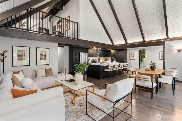 Experience the ultimate in open-concept living in this breathtaking contemporary residence. The centerpiece of the home is a dramatic great room defined by soaring wood ceilings with exposed architectural beams and an expansive wall of windows that seamlessly connects the indoors with nature.    Step into a space designed to take your breath away. This spectacular open-concept great room effortlessly pairs bold, contemporary lines with the organic warmth of soaring, all-wood beamed ceilings. But the true showstopper is the massive wall of windows—featuring 20-foot wide sliding glass doors that effortlessly glide open to blur the line between inside and out. The entire space flows seamlessly onto a huge custom deck, creating an unparalleled layout for summer entertaining or peaceful morning coffees. At the heart of it all sits a gourmet chef’s kitchen, complete with quartz countertops, an abundance of sleek cabinetry, glowing under-cabinet lighting. This is a "home experience"!