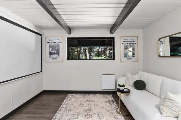 Pop the popcorn and escape to your private main-floor media room. Equal parts cozy and cutting-edge, this designated entertainment space features the home’s signature open-beam ceilings for a striking cinematic atmosphere. Ready for spectacular movie marathons or the big game. And when the credits roll, a horizontal picture window anchors the space back to nature, framing beautiful views of the surrounding forest.