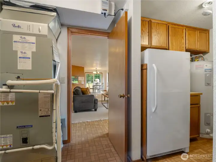 Spacious laundry room off of garage, leading into house. Spacious laundry room off of garage, leading into house.
