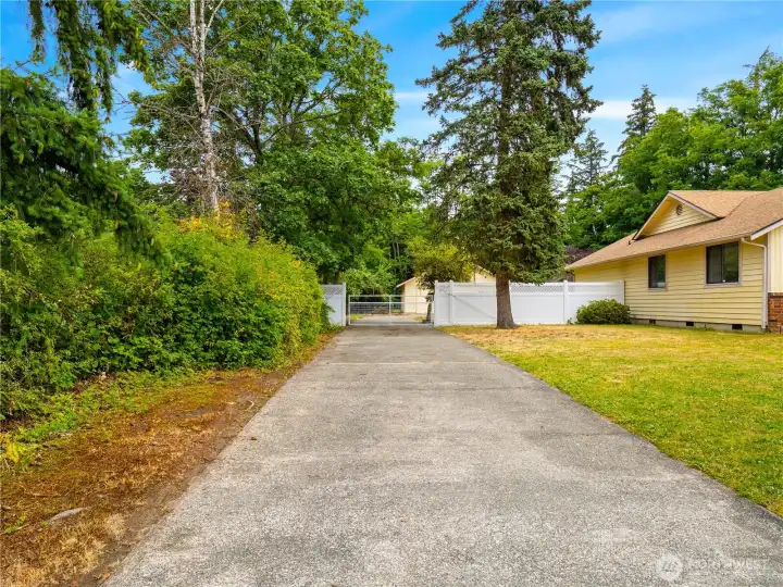Driveway leading to shop through gated access. Driveway leading to shop through gated access.