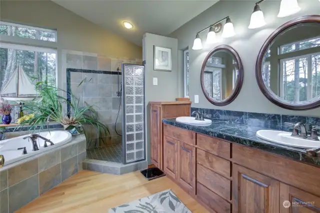 A jetted tub, double vanity with solid countertops and a huge shower!