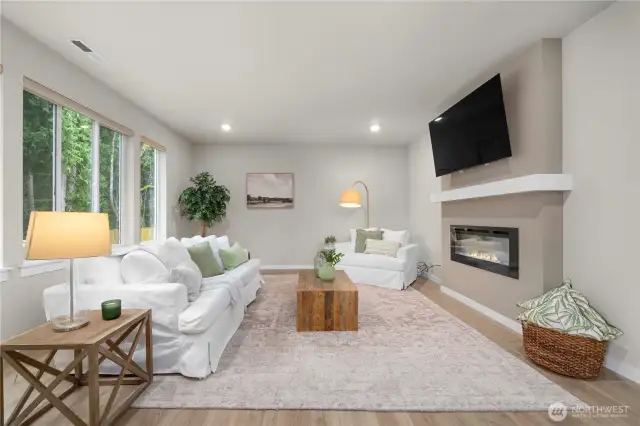 Cozy up to the fireplace in your bright and airy family room!