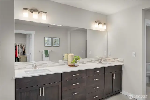 Dual vanity setup and large mirror with tons of cabinetry!