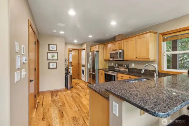 Main floor kitchen with view of laundry area