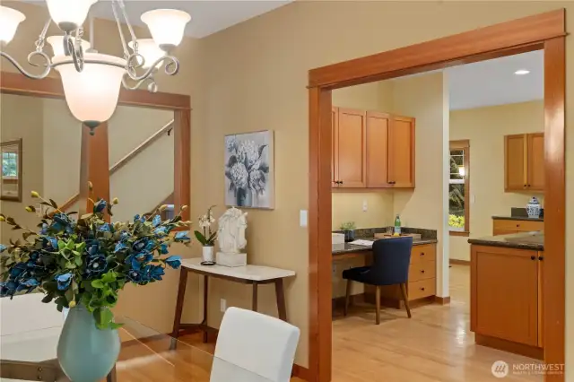This view shows the open flow to the generous kitchen which includes a built-in desk - makes a great spot for managing household tasks or planning meals.