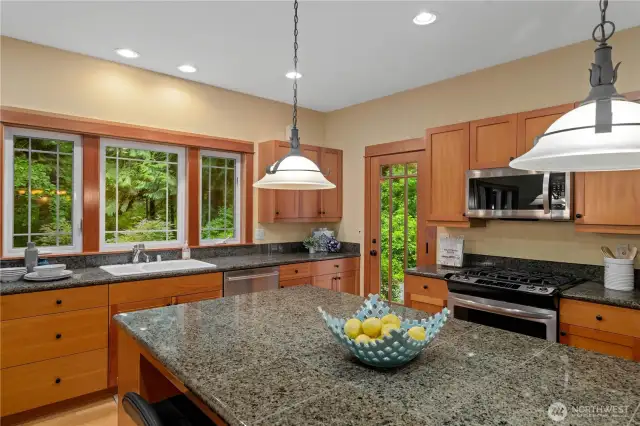 The large central island serves as both a practical prep area and a stylish gathering spot, complete with seating for casual dining or entertaining guests.
