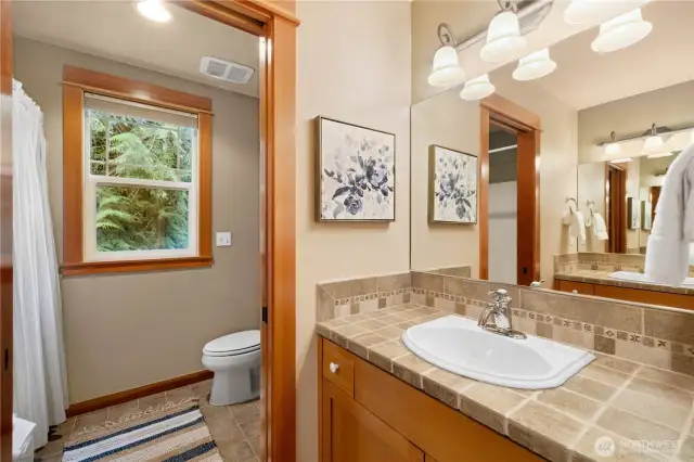 The second full bathroom upstairs has pocket doors to close off the shower area.  Two sinks back up to each other and include plenty of storage.