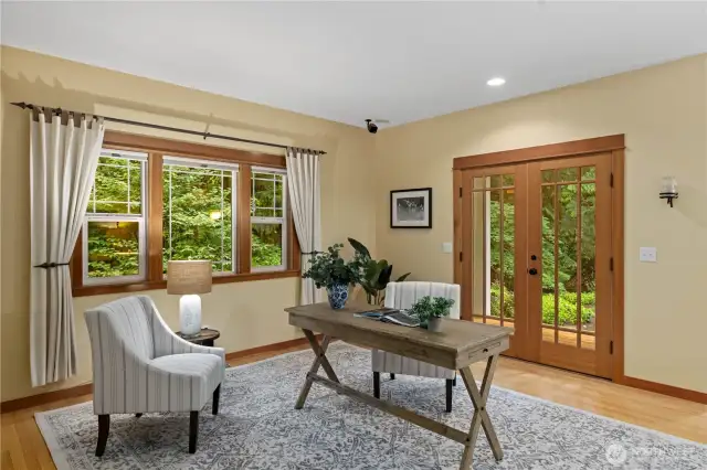 The den also features French doors that flow out to the level backyard.