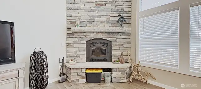 Floor-to-ceiling stone fireplace adds warmth and intimacy