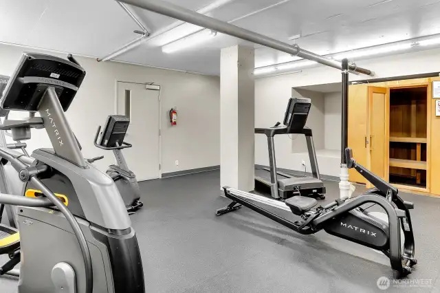Large fitness center with free weights, machines, cardio equipment, and sauna