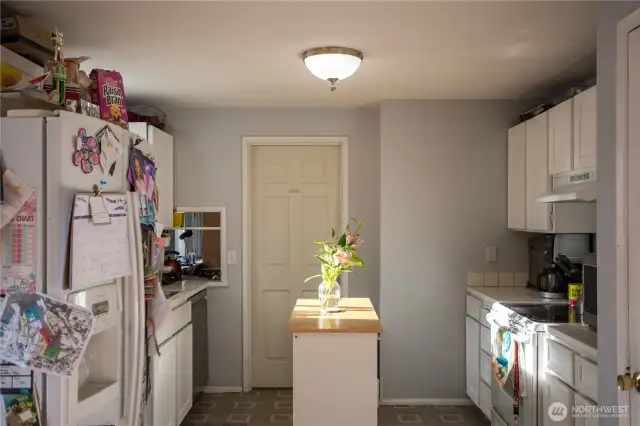spacious kitchen with entry to den/office or formal eating area.