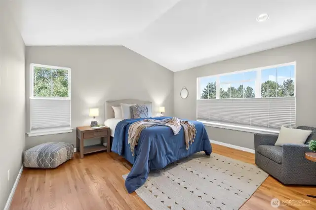 Beautiful primary bedroom and en-suite with views of the gardens