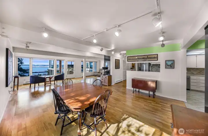 View from dining area far wall looking toward kitchen and living space