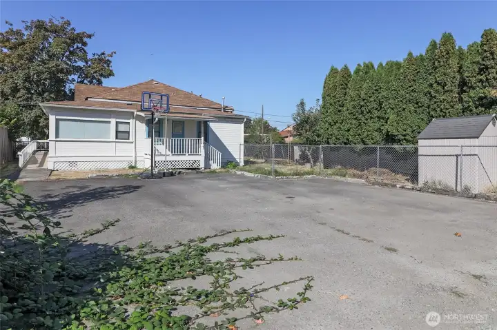 Parking pad in back of home holds many cars!  The shed also stays!