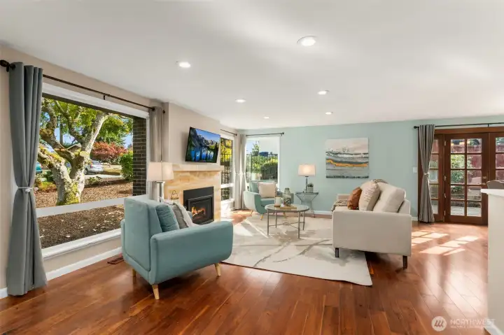 Floor-to-ceiling windows flood the living room with natural light.